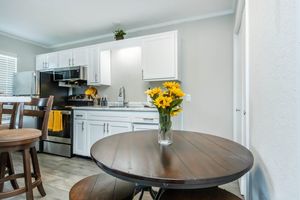 a room filled with furniture and vase of flowers on a table