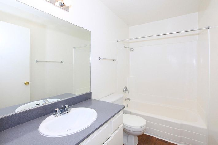 Unfurnished bathroom with white cabinets