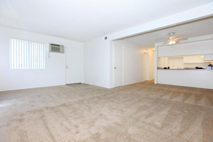 Unfurnished living room and dining room with carpet