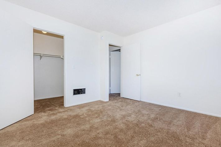 Bedroom with open walk-in closet door