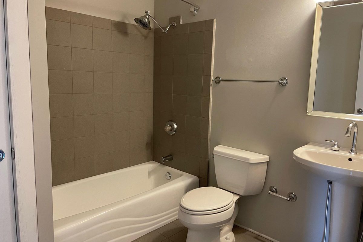 a shower that has a sink and a mirror