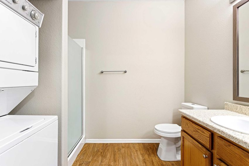bathroom with stackable washer dryer