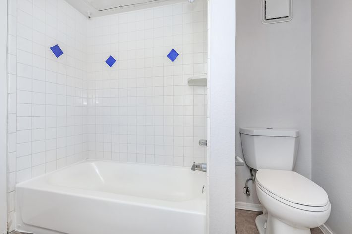 a white sink sitting under a window