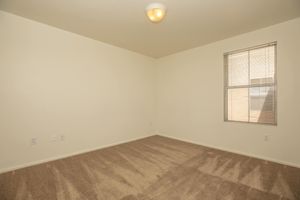 carpeted bedroom with a window