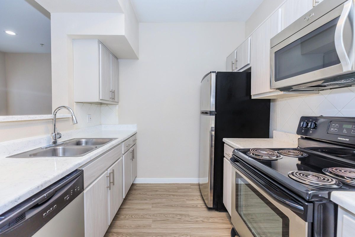 a kitchen with a stove and a sink