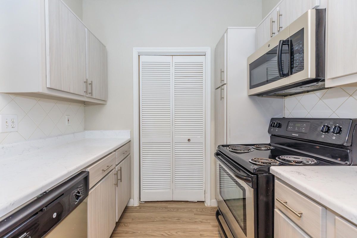 a stove top oven sitting inside of a kitchen