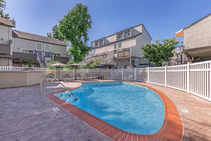 a house with a pool in front of a building