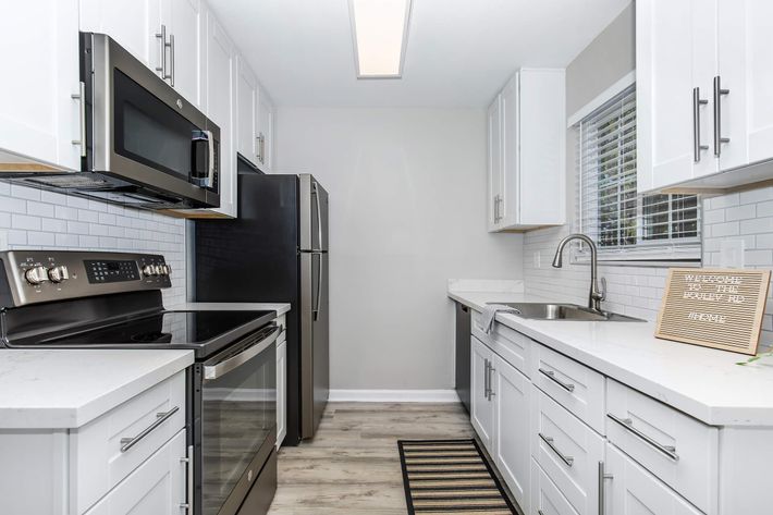 a stove top oven sitting inside of a kitchen