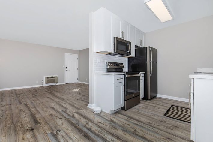 a kitchen with a refrigerator in a room