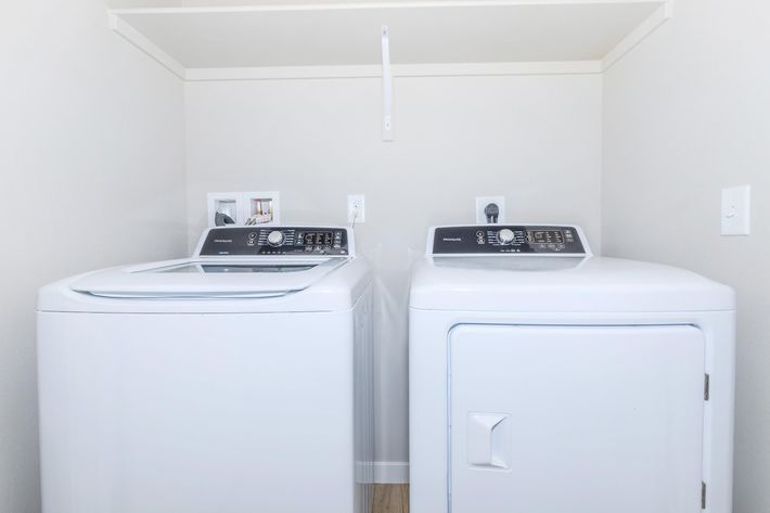 a microwave oven sitting on top of a refrigerator