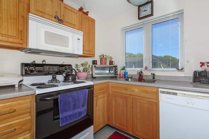 a kitchen with a stove a sink and a microwave