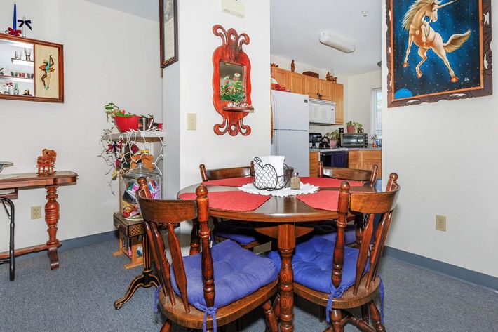 a bedroom with a desk and chair in a room