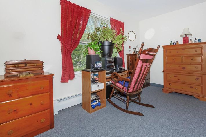 a bedroom with a bed and desk in a small room