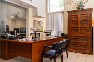 a dining room table in front of a window