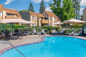 a house with a pool outside of a building