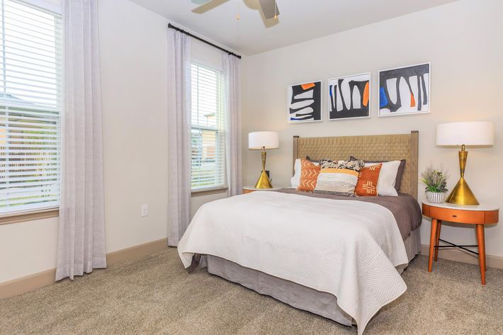 a bedroom with a bed and desk in a room