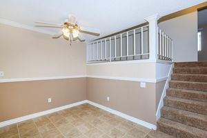 Dining room with carpeted stairs