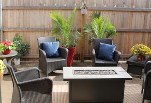 a fire pit with wicker chairs