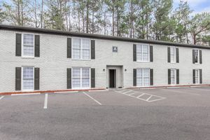 an empty parking lot in front of a house