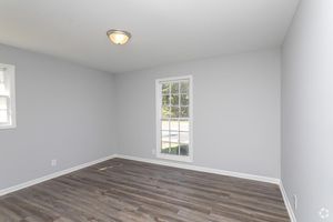 a large empty room with a wooden floor