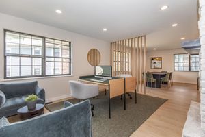 a living room filled with furniture and a large window