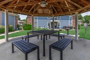 an empty park bench next to a building