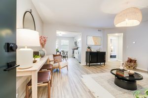 Front entrance and furnished platinum living room interior at The Arbor in Blue Springs