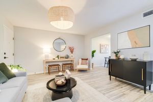 Platinum living room interior with area carpeting, couch and furniture at The Arbor in Blue Springs