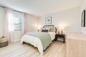 Bed and furniture inside platinum bedroom interior at The Arbor in Blue Springs, Missouri