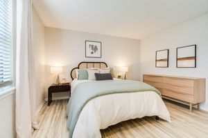 Bed and furniture inside platinum bedroom interior at The Arbor in Blue Springs, Missouri