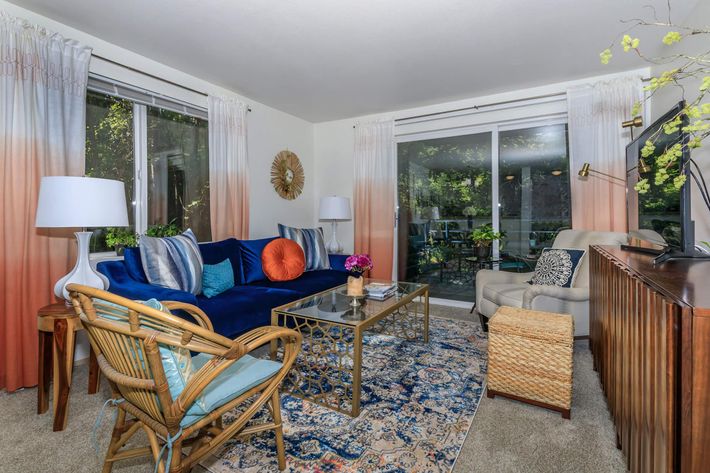 a living room filled with furniture and a window