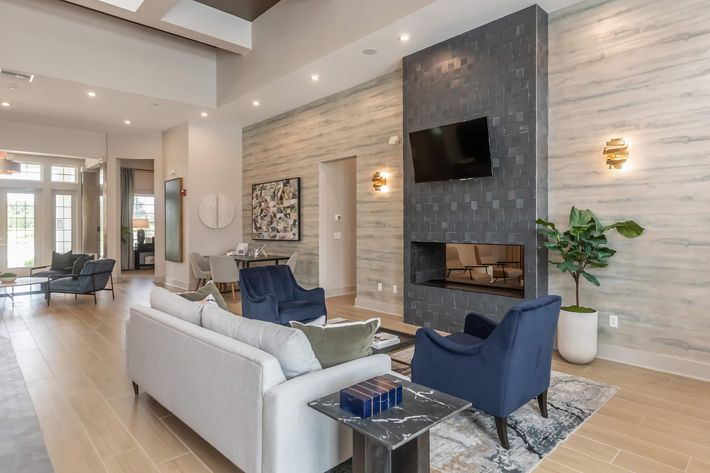 a living room filled with furniture and a large window