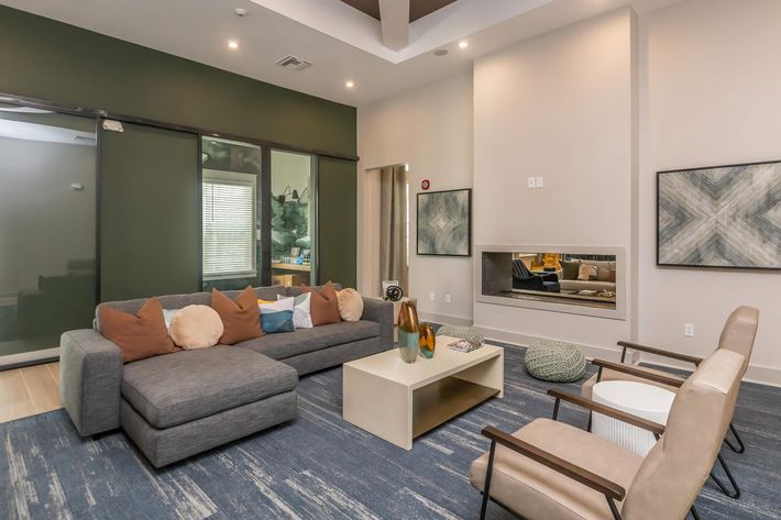 a living room filled with furniture and a large window