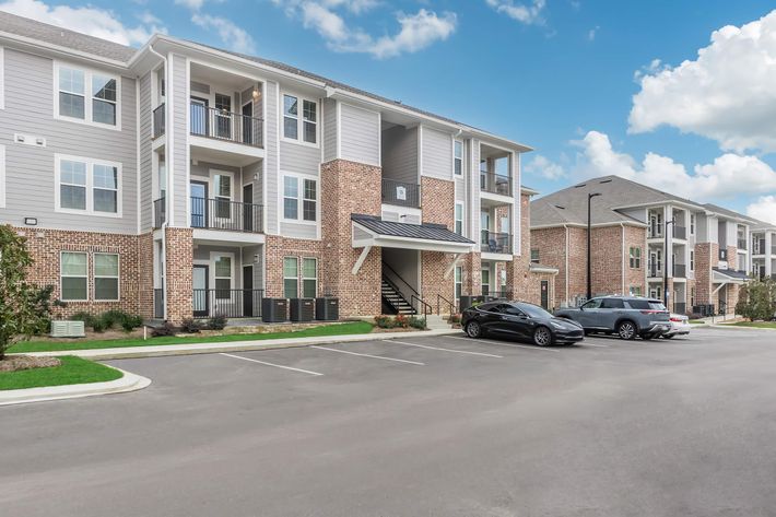 a large brick building with a parking lot