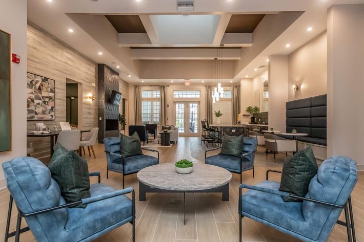 a living room filled with furniture and a large window