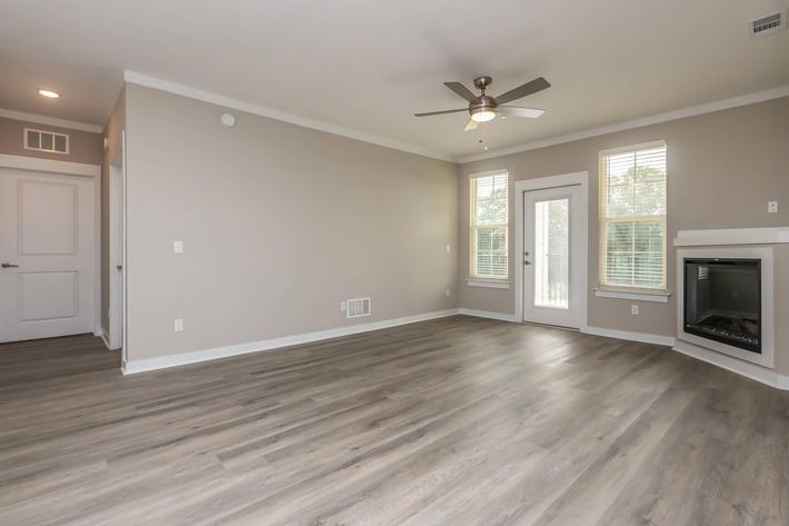 a large empty room with a wood floor