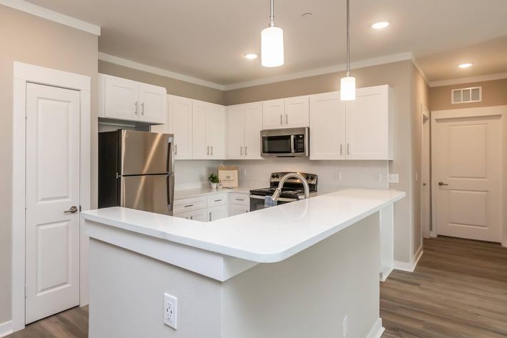 a kitchen with a sink and a refrigerator