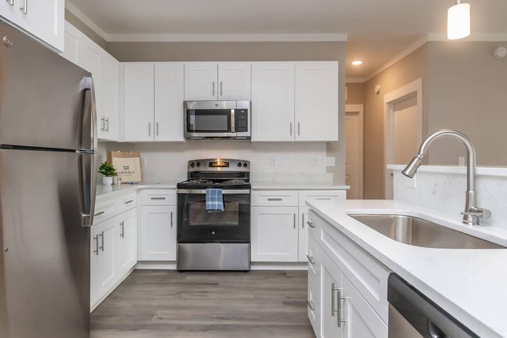 a kitchen with a stove sink and refrigerator