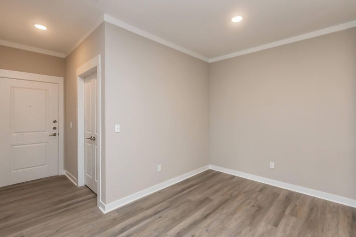 a large empty room with a wood floor