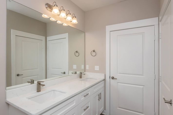 a kitchen with a sink and a mirror