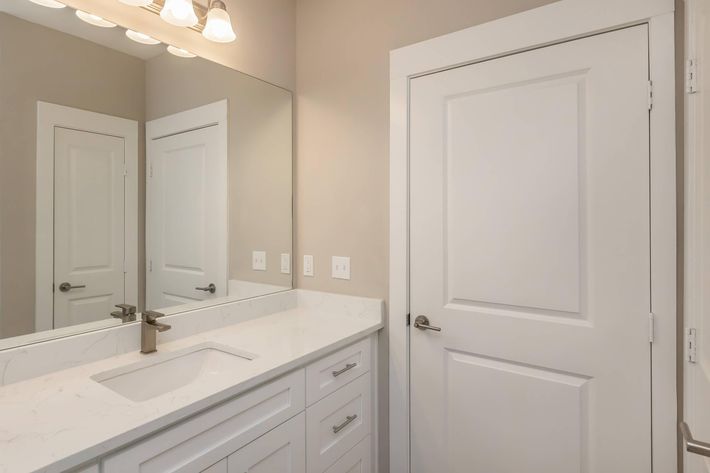 a kitchen with a sink and a mirror