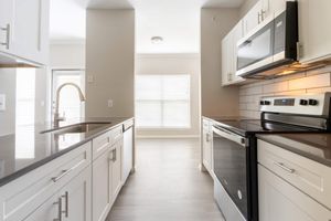 a kitchen with a sink and a window