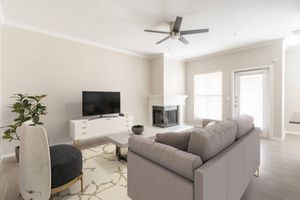 a living room filled with furniture and a large window