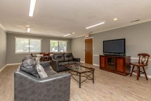 a living room filled with furniture and a tv