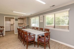 a dining room table in front of a window