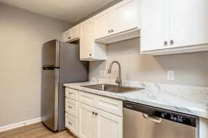 a kitchen with a sink and a mirror