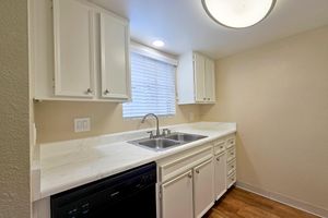 a stove top oven sitting inside of a kitchen