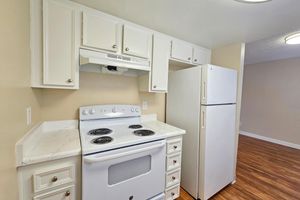 a stove top oven sitting inside of a kitchen