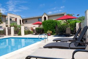 a house with a pool in front of a building