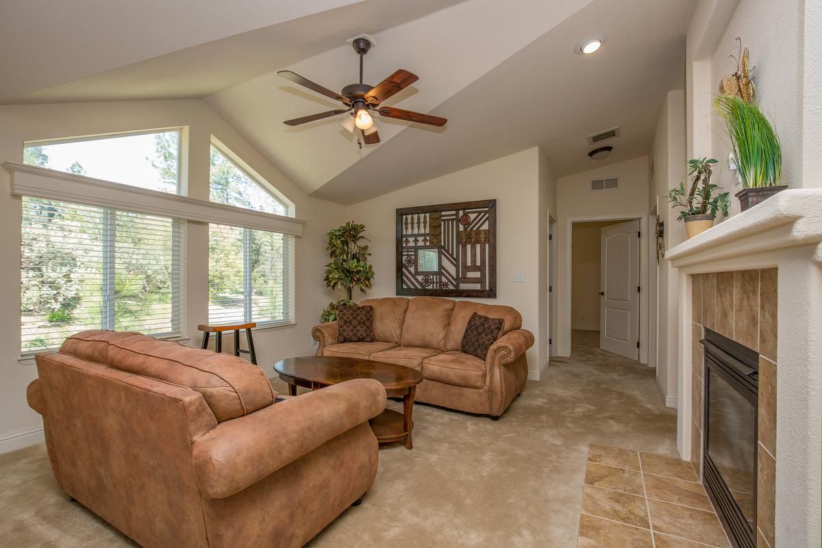 a living room filled with furniture and a large window